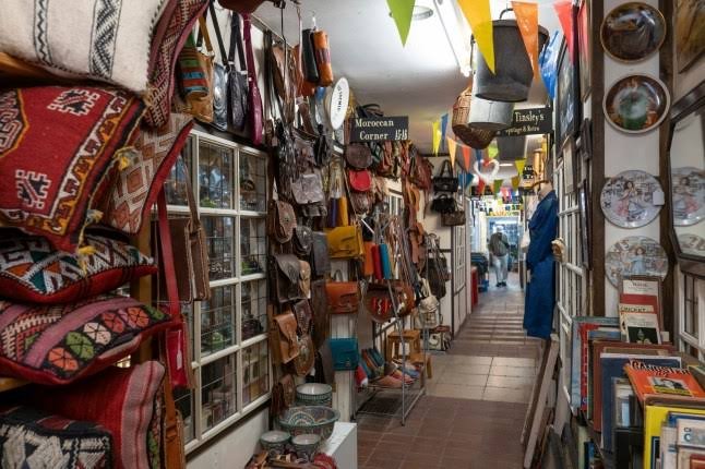 Inside the market corridor, lined with leather bags, rugs and homeware