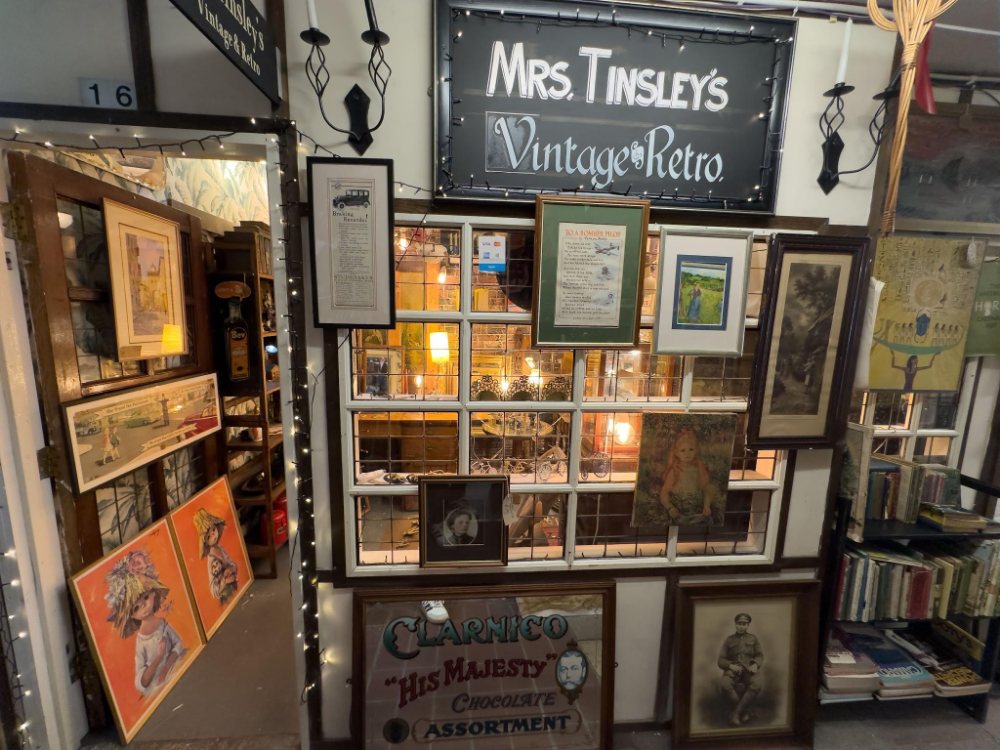 Mrs Tinsley's Vintage and Retro, framed pictures and prints hung around the shop window