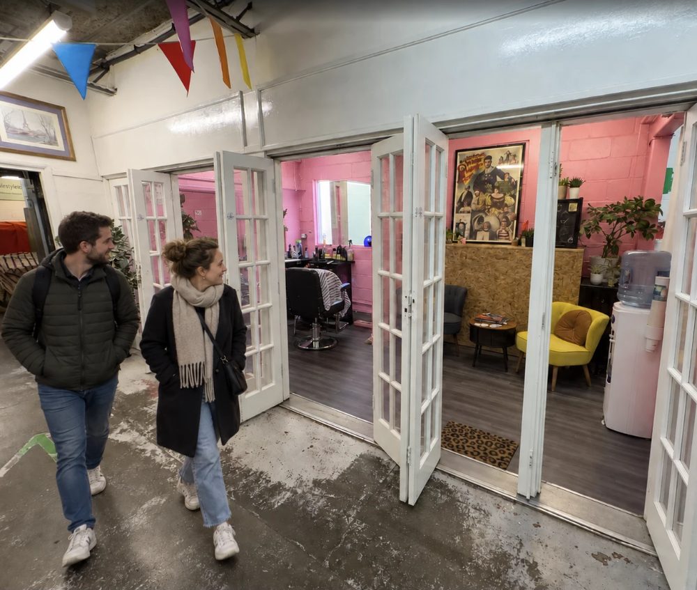 Timmy Tapers, pink walls and a barber’s chair behind a run of open glazed doors, with a yellow armchair in the waiting area