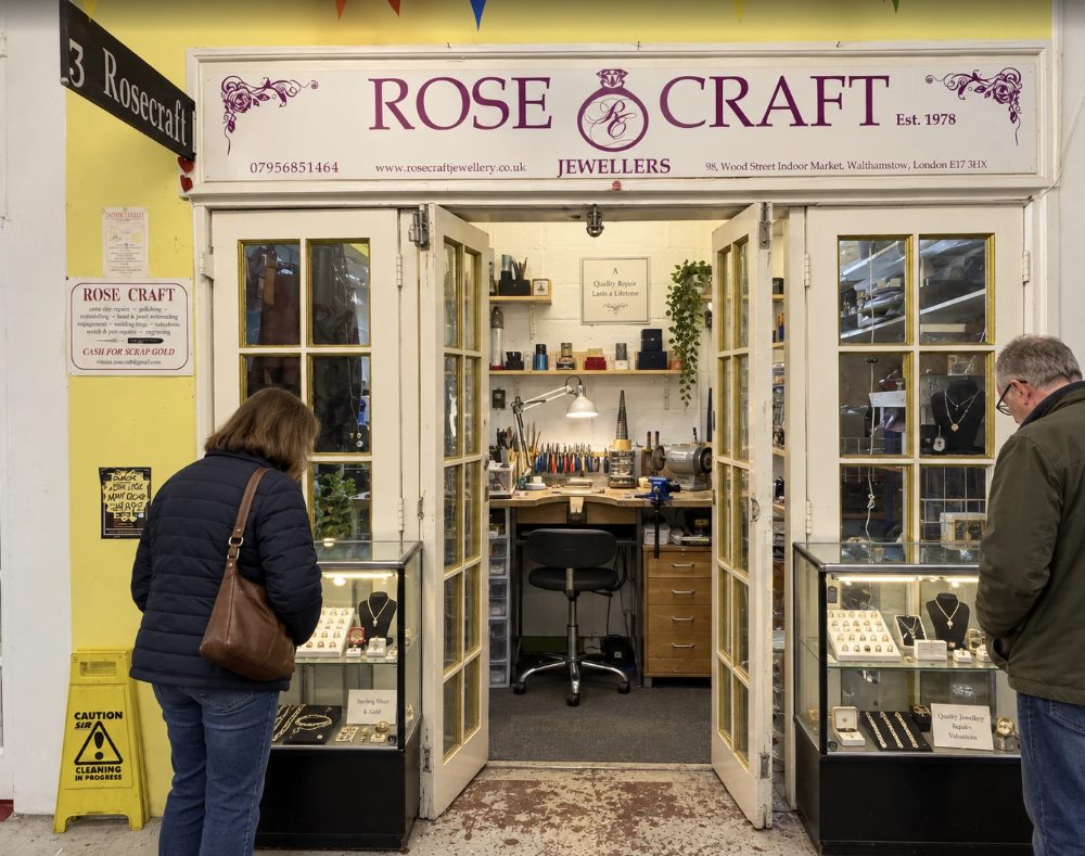 RoseCraft Jewellers, open double doors under the shop sign onto a jeweller’s bench, with cases of rings and necklaces either side