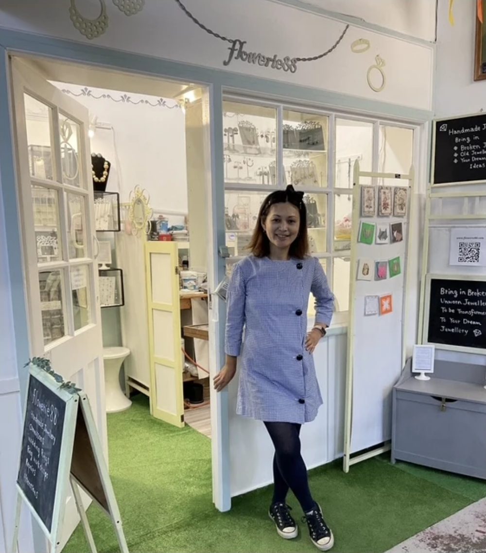 Flowerie88, a pale blue and white jewellery unit with its name in wire script above the door, display cases of handmade pieces inside and a chalkboard at the front